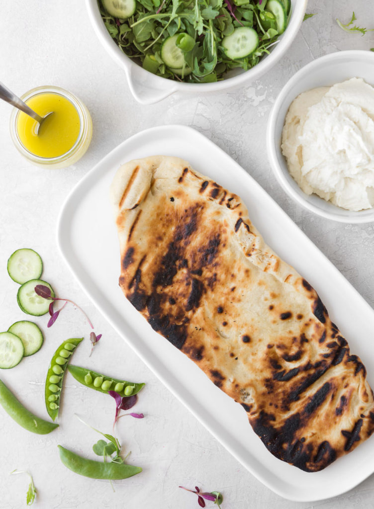 grilled flatbread salad with arugula, ricotta and peas