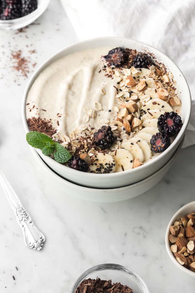 banana nut smoothie bowl with tahini, honey and almonds