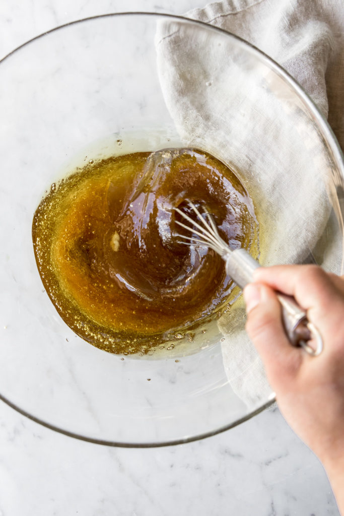 whisking olive oil and maple syrup