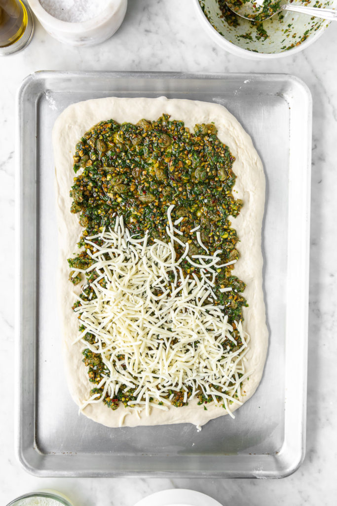 assembly of stuffed focaccia with pesto and mozzarella