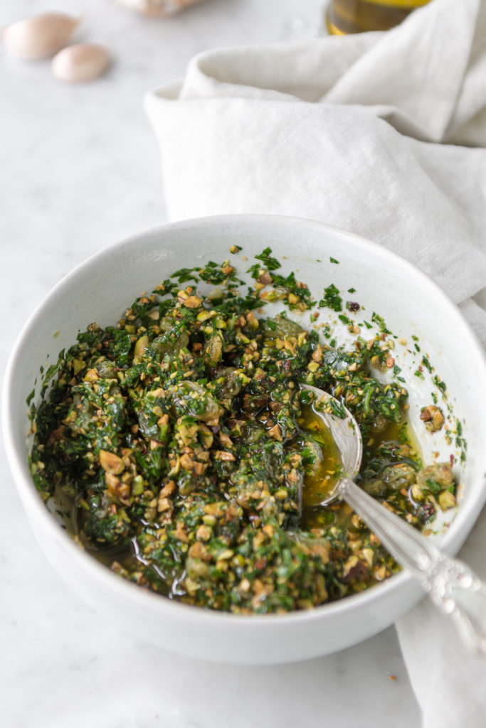 pistachio parsley pesto with golden raisins and chiles flakes