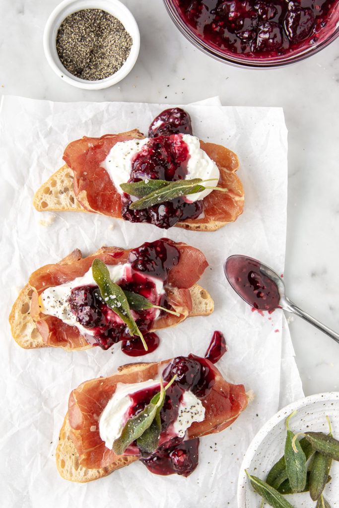 burrata crostini with prosciutto, blackberries and fried sage