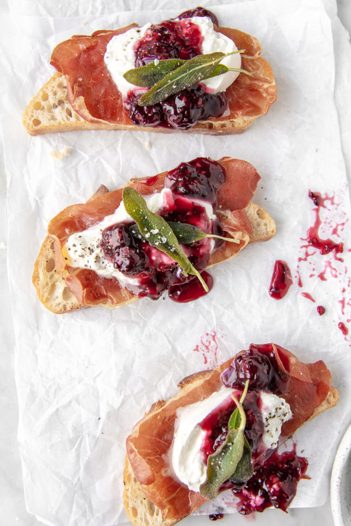 burrata crostini with prosiutto, blackberry honey sauce and fried sage leaves