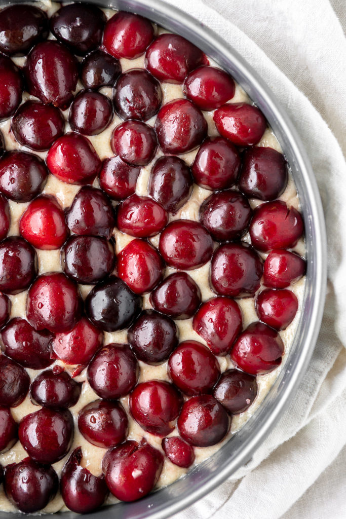 cherries arranged cut side down on cake batter