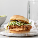 spicy fried chicken sandwich with sriracha mayonnaise and jalapeno slaw