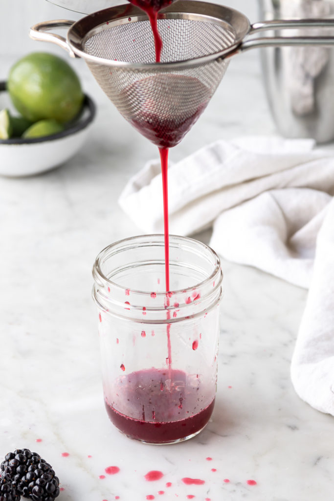 straining blackberry simple syrup