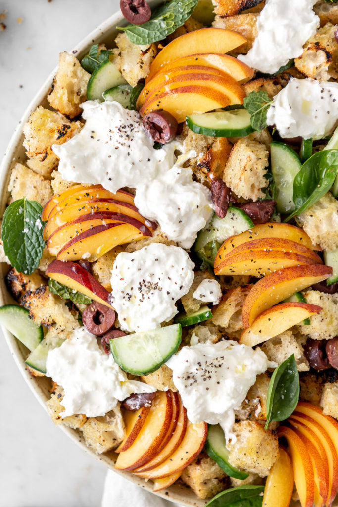 summer panzanella salad with burrata, cucumber, olives and peaches