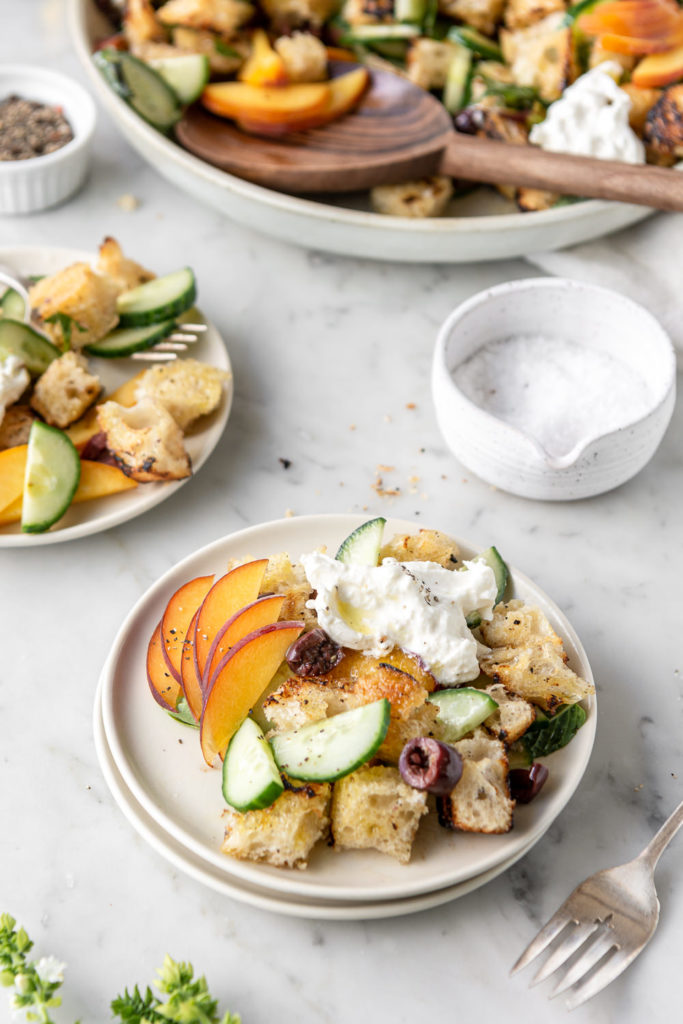 summer panzanella salad with peaches, cucumber, burrata, olives, mint and basil