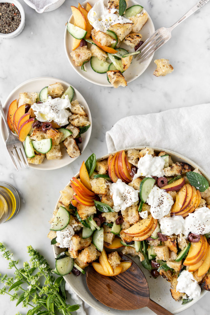summer panzanella with peaches, burrata, olives, cucumber and herbs
