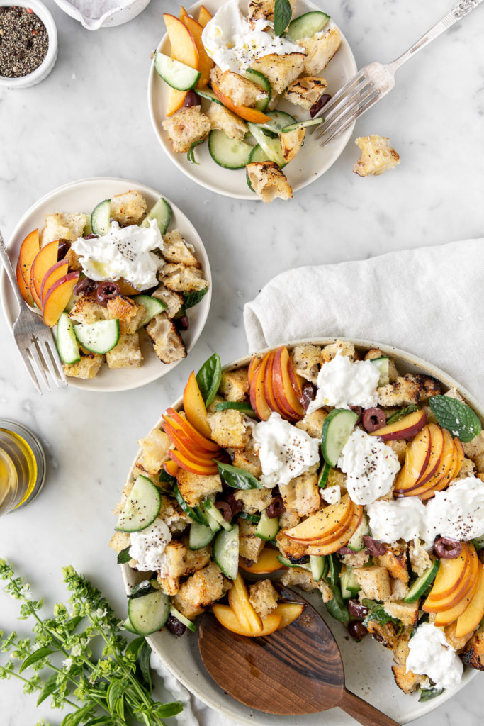 summer panzanella with peaches, burrata, olives, cucumber and herbs
