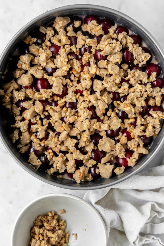 unbaked cake topped with walnut streusel