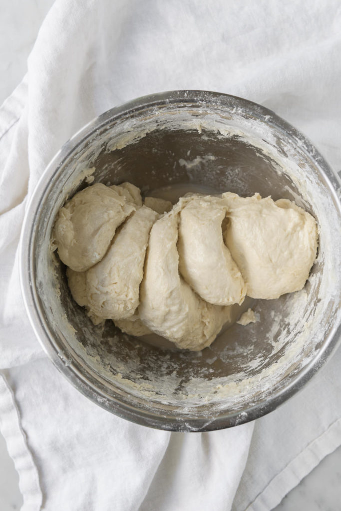 pinching through dough to mix yeast and salt