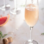 topping grapefruit mimosa with prosecco