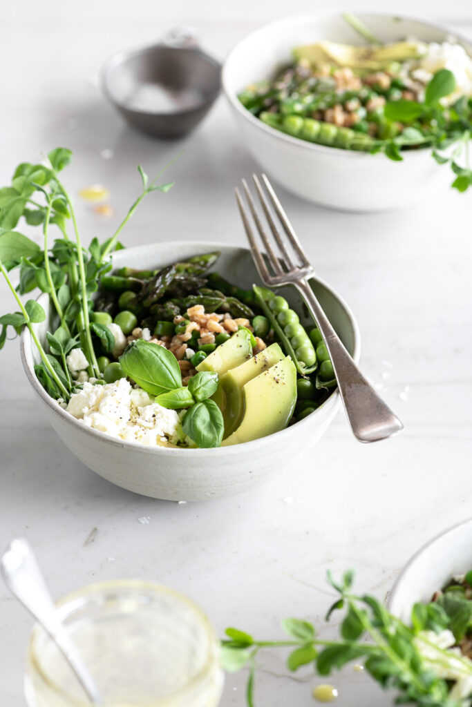 farro grain bowl with asparagus, avocado, peas and feta