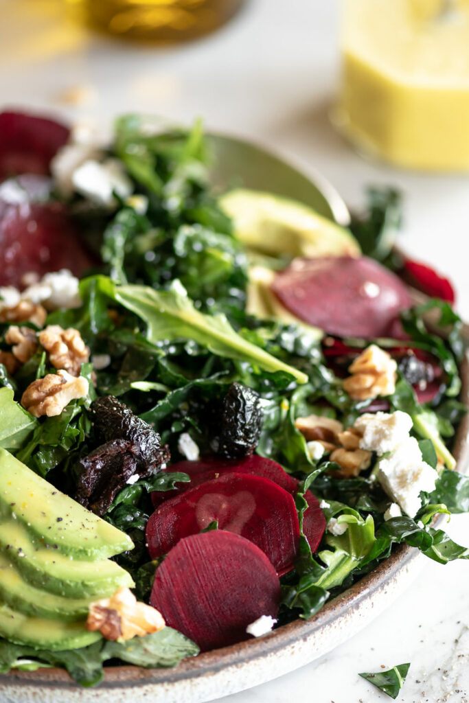 raw beet salad with avocado, oil cured olives, goat cheese and walnuts