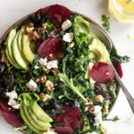 raw beet salad with avocado, olives, goat cheese and walnuts