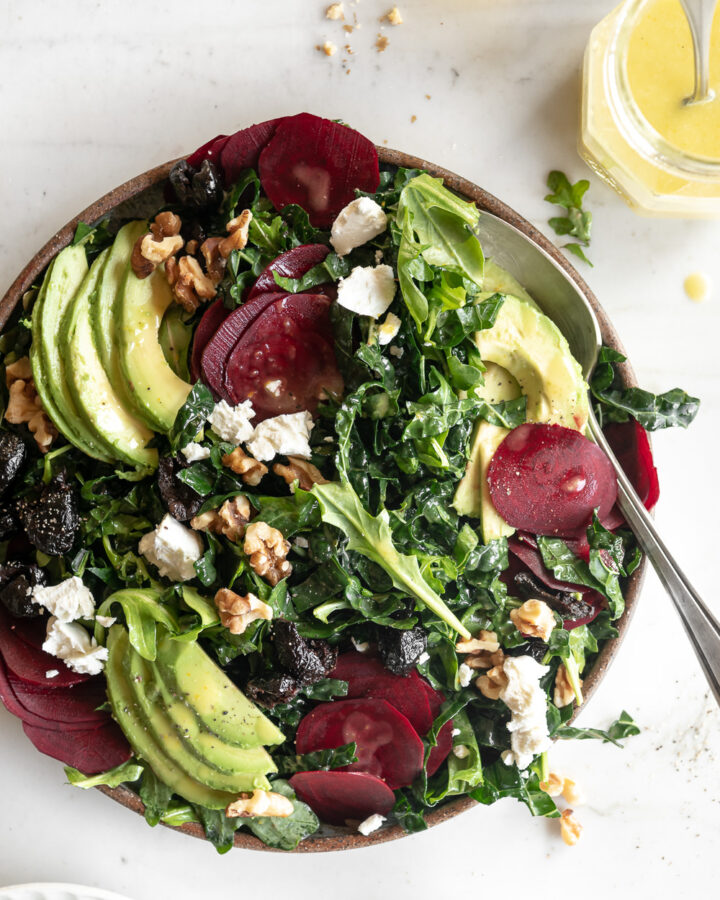 raw beet salad with avocado, olives, goat cheese and walnuts