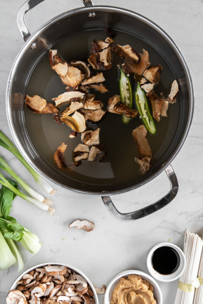 steeping mushrooms, kombu and peppers in broth