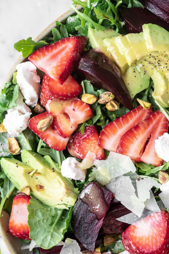 roasted beet salad with goat cheese and pistachios, avocado, strawberries and preserved lemon vinaigrette