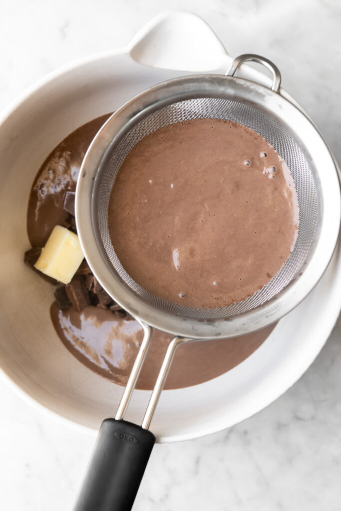 strain custard onto chopped chocolate to make dark chocolate pudding