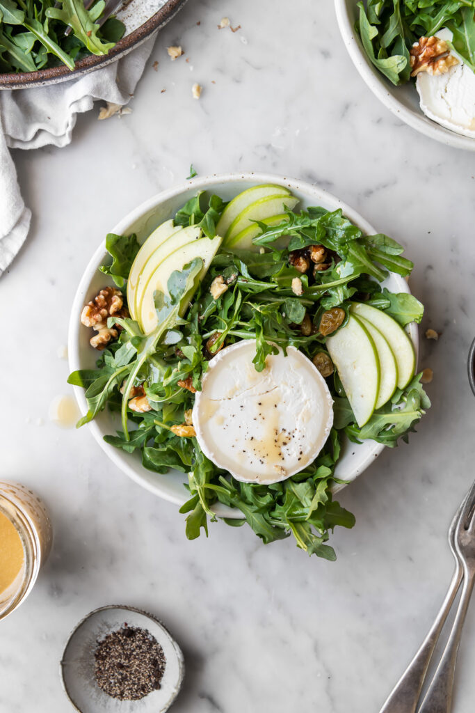 apple arugula salad with goat cheese, pickled raisins and walnut dressing