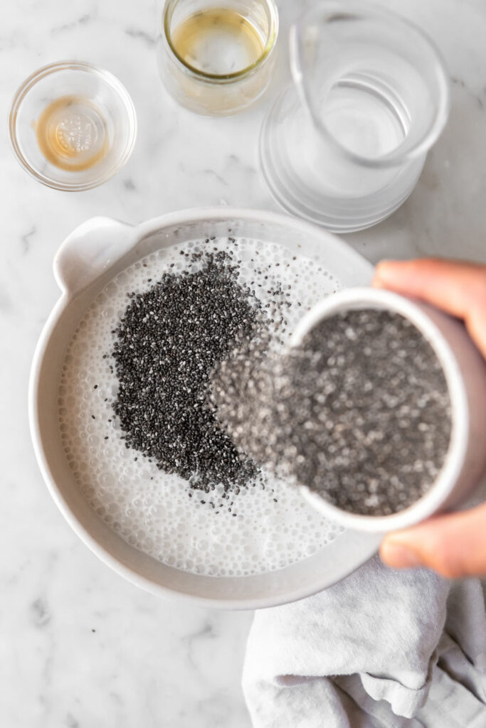 adding chia seeds to yogurt and almond milk mixture