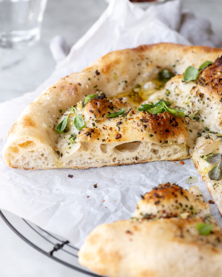 pizza with garlic butter sauce and herbs