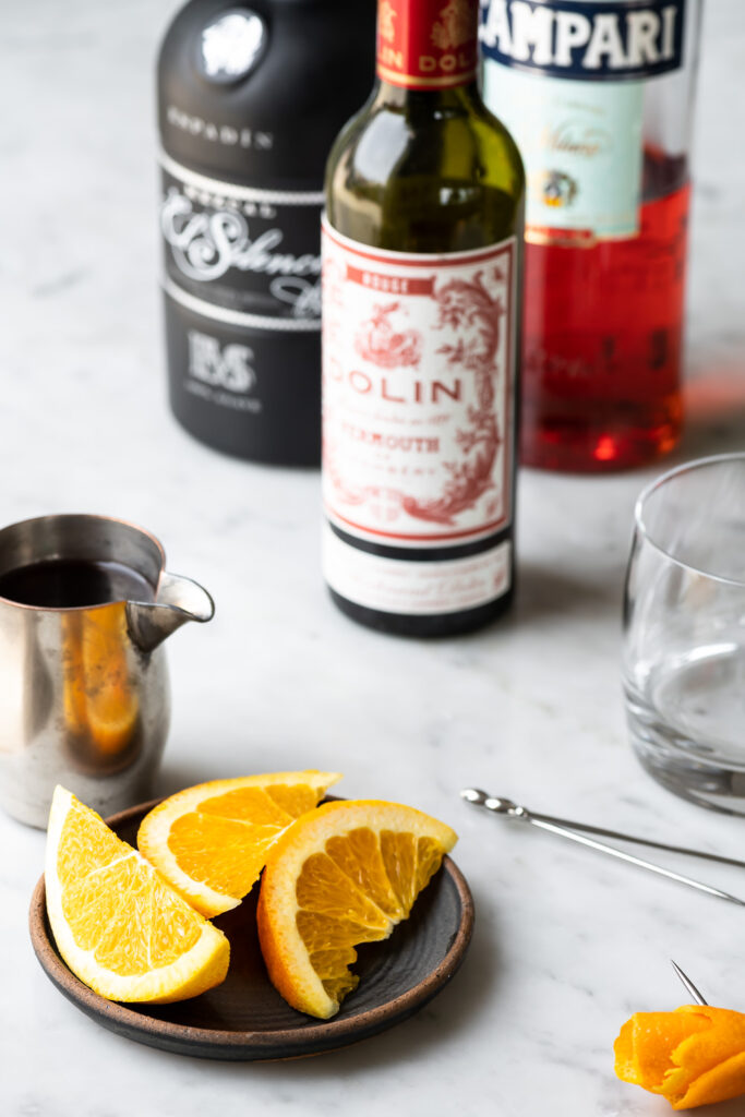 mezcal, campari, sweet vermouth, orange twists