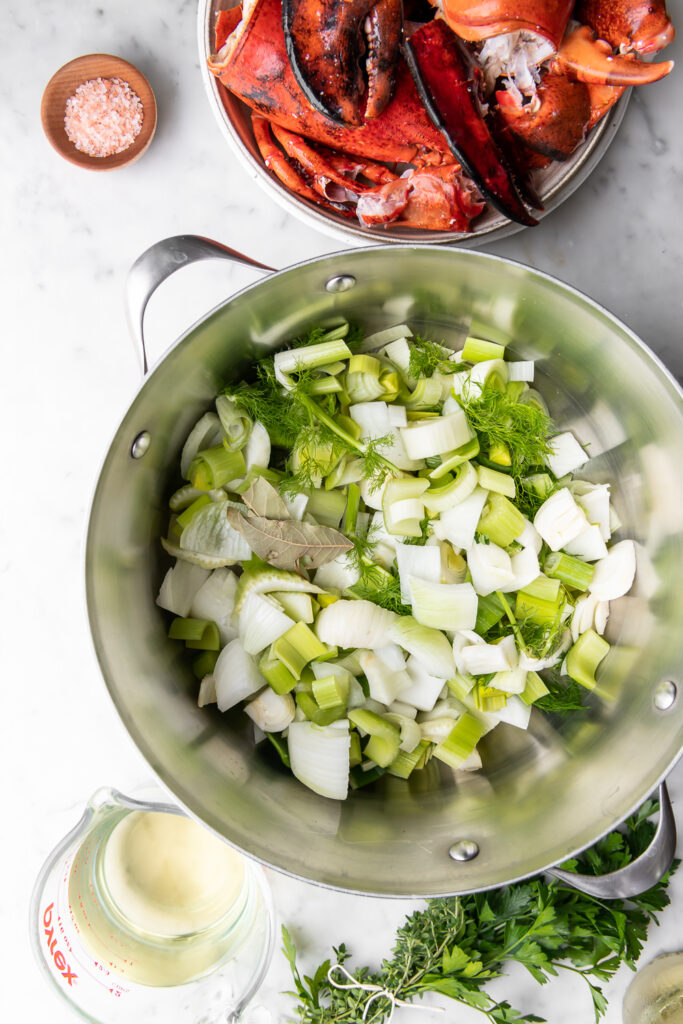 sauteed aromatics with lobster shells and white wine