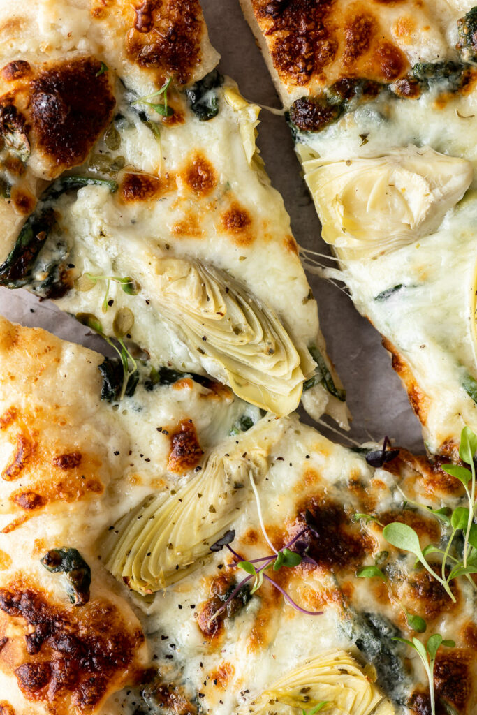 artichoke pizza with creamy spinach sauce