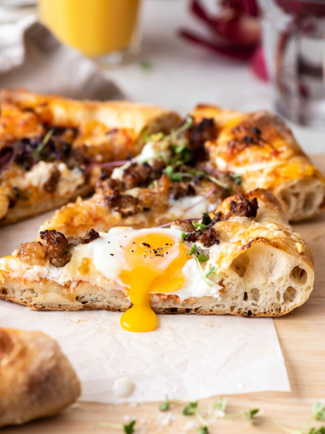 sausage breakfast pizza with eggs and caramelized onion