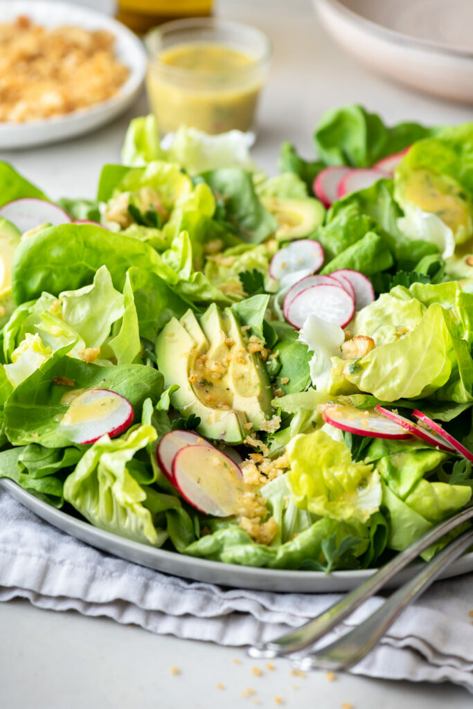 simple butter lettuce salad with avocado, radishes and breadcrumbs