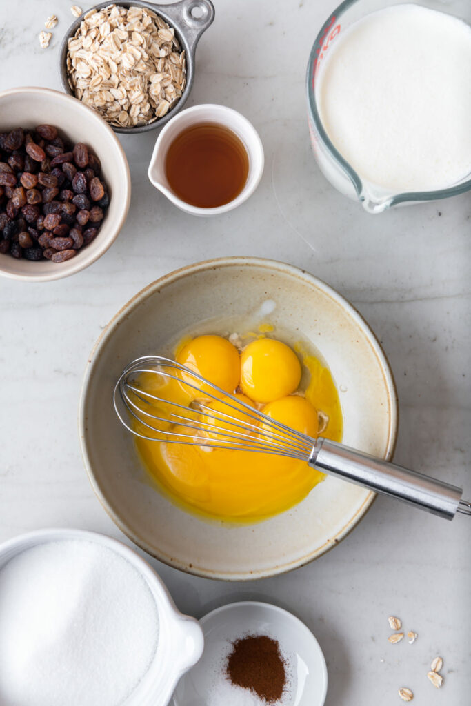 egg yolks, cream, milk, sugar, rum, raisins, oats, cinnamon