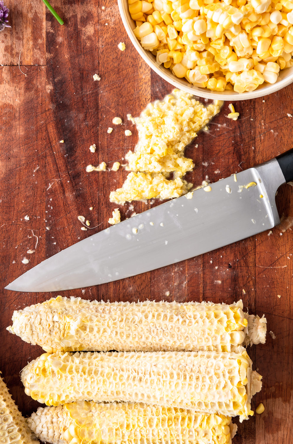 scraping corn cobs for corn milk