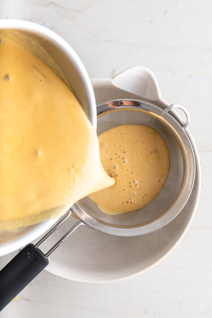 straining pumpkin custard