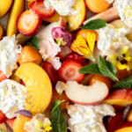 peach burrata salad with herbs and edible flowers